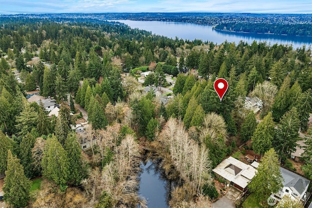 aerial view with a forest view and a water view