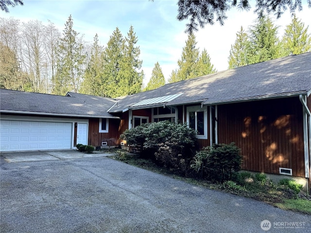 single story home with a garage and driveway