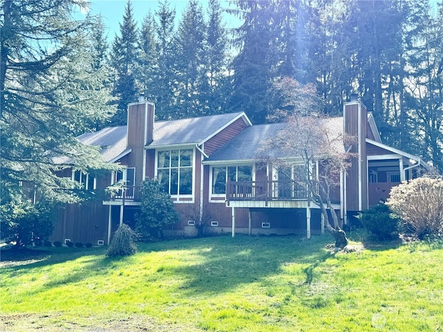 back of property with crawl space, a chimney, and a yard