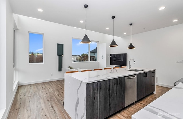 kitchen featuring recessed lighting, a sink, light wood-style flooring, and stainless steel dishwasher