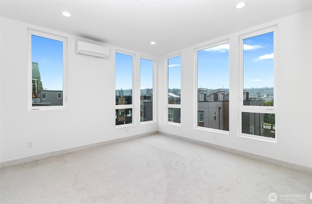 carpeted spare room with plenty of natural light, recessed lighting, baseboards, and a wall mounted air conditioner