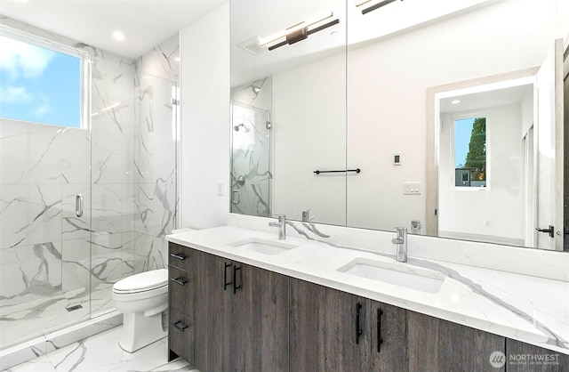 bathroom with toilet, marble finish floor, a marble finish shower, and a sink