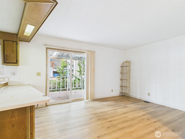 unfurnished living room with light wood-style floors and baseboards