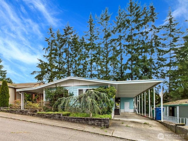 view of front of home featuring an attached carport and driveway