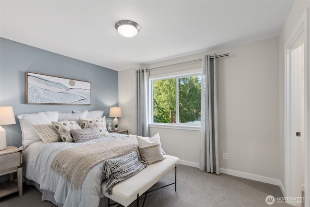 bedroom featuring light colored carpet and baseboards