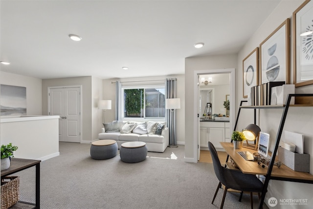 carpeted living area featuring recessed lighting and baseboards