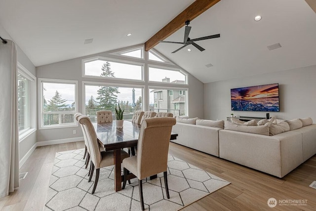 dining room featuring light wood-type flooring, beamed ceiling, high vaulted ceiling, a ceiling fan, and baseboards