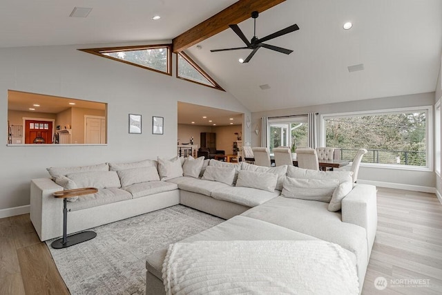 living area featuring baseboards, beamed ceiling, wood finished floors, high vaulted ceiling, and a ceiling fan