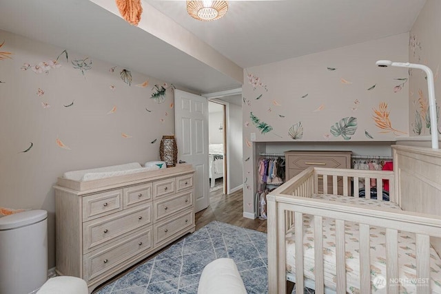 bedroom featuring baseboards and wood finished floors