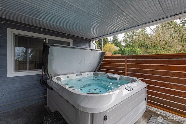 deck featuring fence and a hot tub