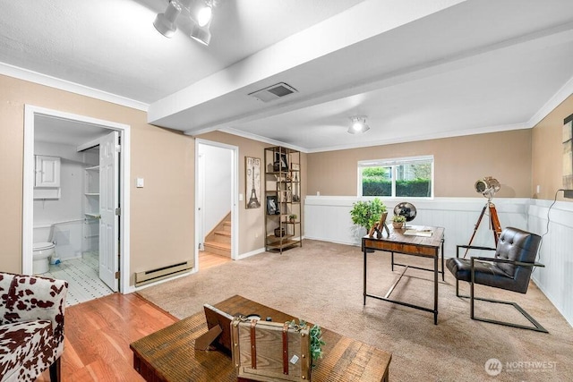 living area with crown molding, wainscoting, visible vents, and a baseboard radiator