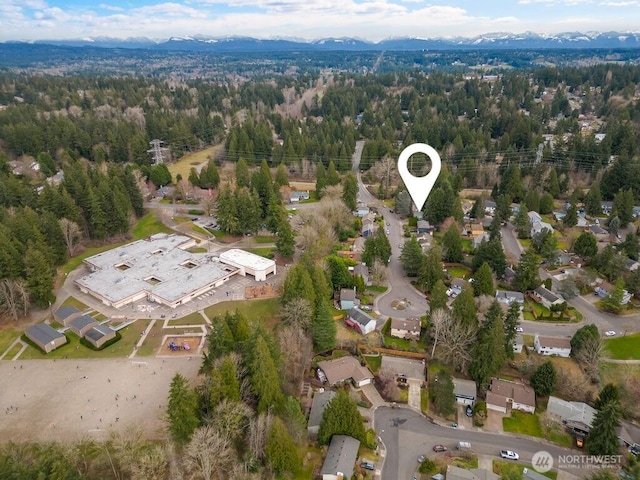 birds eye view of property with a view of trees and a mountain view