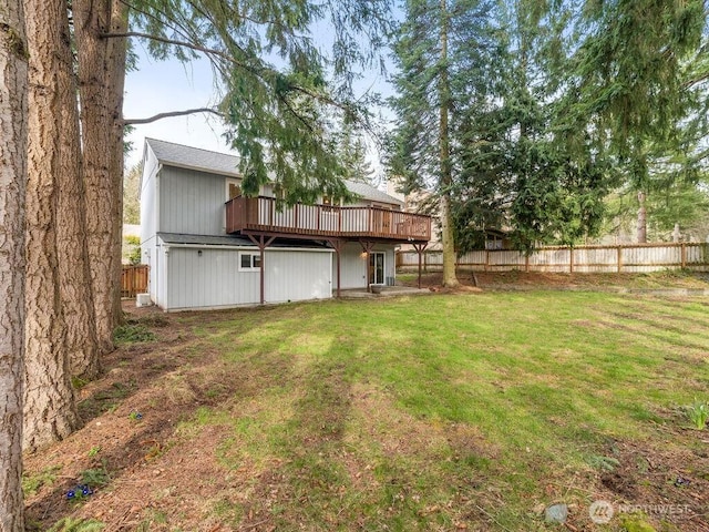 view of yard with a deck and fence