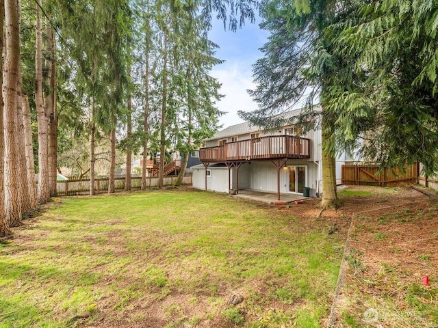 view of yard featuring a deck, a patio area, and a fenced backyard