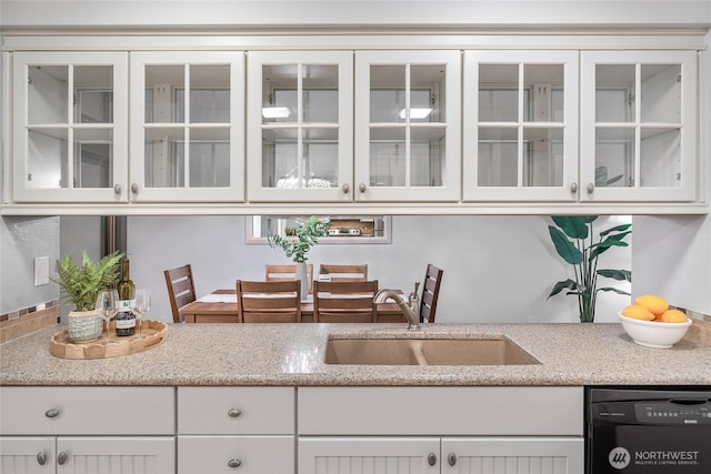 kitchen featuring a sink, glass insert cabinets, dishwasher, and white cabinets