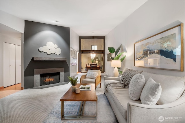 living area featuring a warm lit fireplace