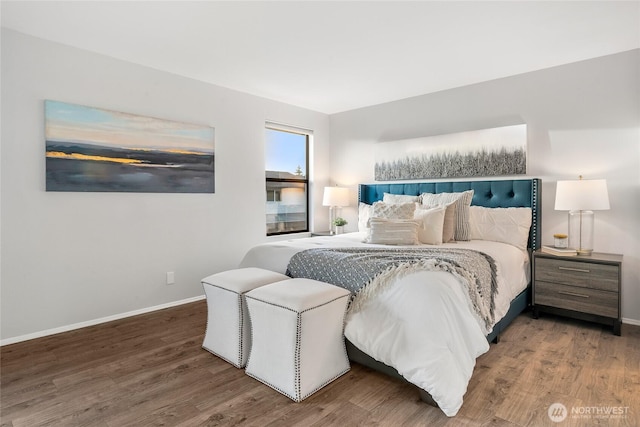 bedroom featuring wood finished floors and baseboards