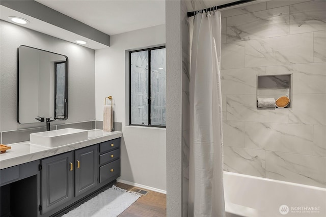 bathroom with vanity, wood finished floors, baseboards, recessed lighting, and shower / bath combination with curtain