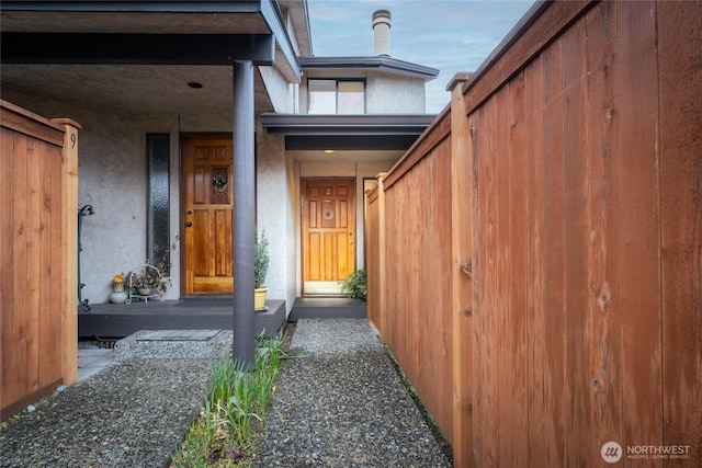 property entrance featuring stucco siding