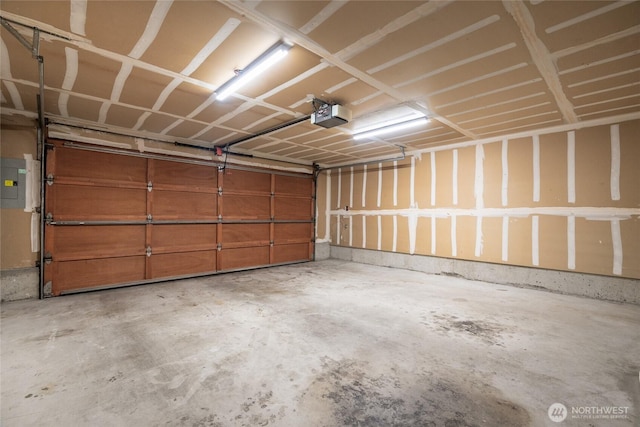 garage with electric panel and a garage door opener