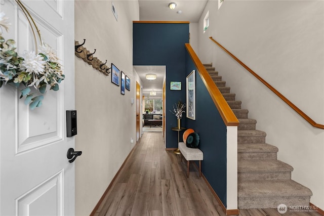 interior space featuring a high ceiling and wood finished floors