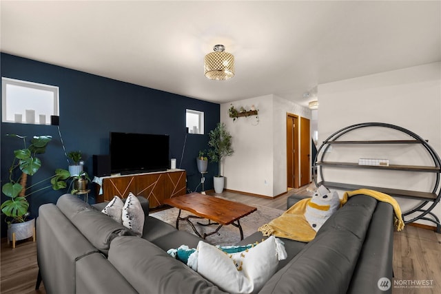 living area featuring baseboards and wood finished floors