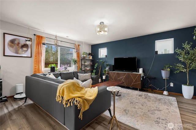 living room featuring wood finished floors and baseboards