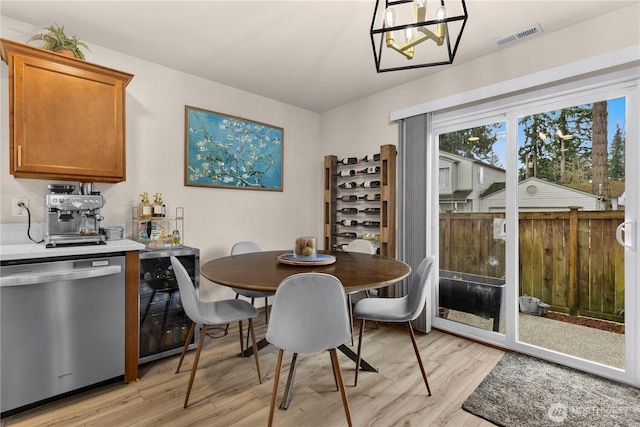 dining space with visible vents and light wood-type flooring