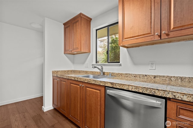 kitchen with dark wood-style flooring, a sink, tile counters, dishwasher, and brown cabinets