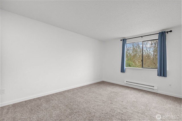 carpeted spare room featuring a textured ceiling, baseboards, and a baseboard radiator