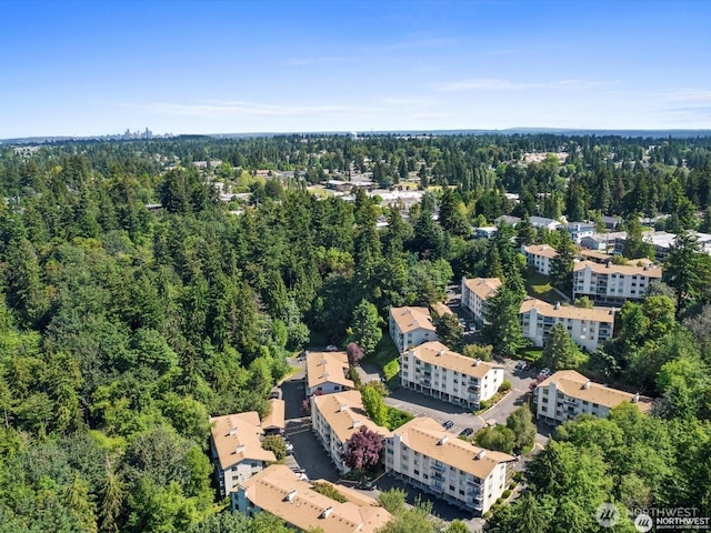 drone / aerial view featuring a forest view