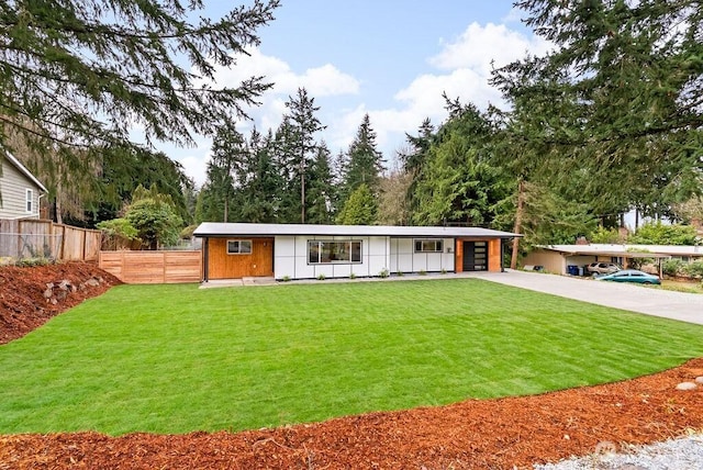 view of front of house with a garage, driveway, a front yard, and fence