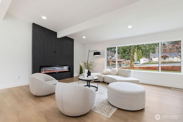 living room with baseboards, beamed ceiling, recessed lighting, a fireplace, and wood finished floors