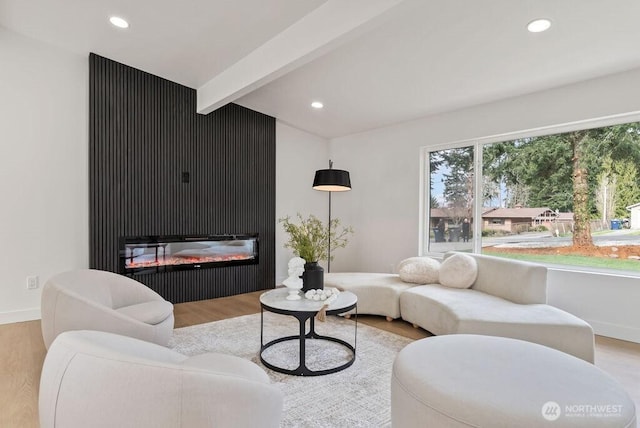 living room with recessed lighting, beamed ceiling, and wood finished floors