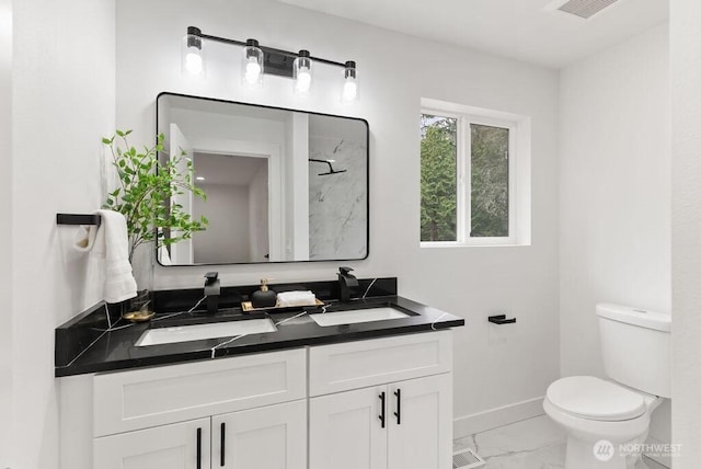 full bath with marble finish floor, toilet, baseboards, and a sink