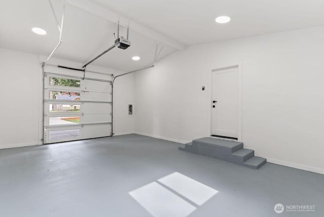 garage featuring recessed lighting, a garage door opener, and baseboards