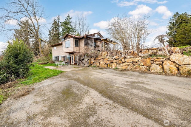 view of side of home featuring driveway