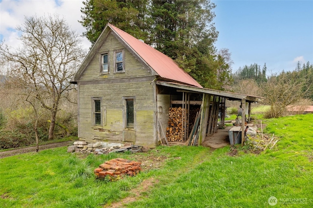 exterior space with a yard and metal roof