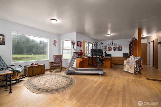 interior space with baseboards and light wood finished floors