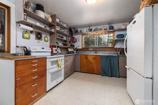 kitchen featuring white appliances, brown cabinets, light floors, a sink, and open shelves