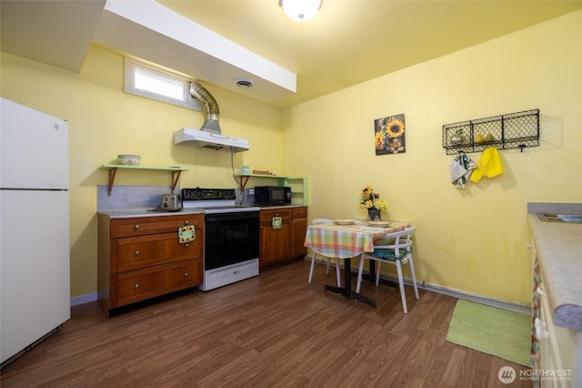 kitchen with electric range oven, black microwave, freestanding refrigerator, dark wood-style floors, and brown cabinetry