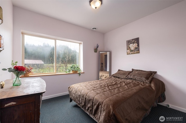 bedroom featuring baseboards, visible vents, and carpet