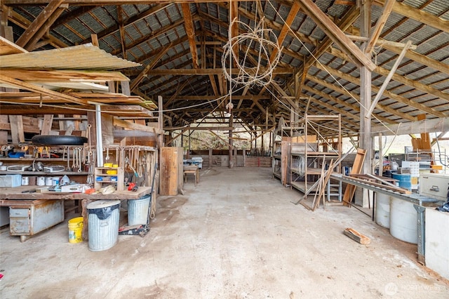 miscellaneous room featuring a workshop area and vaulted ceiling