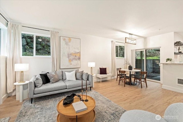 living room featuring an inviting chandelier and light wood-style flooring