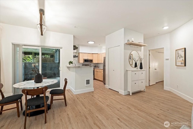 dining space featuring visible vents, baseboards, and light wood-style floors