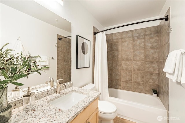 bathroom with vanity, shower / bath combination with curtain, and toilet