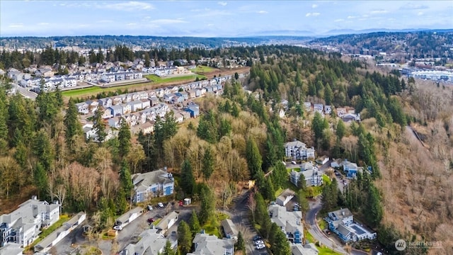 birds eye view of property featuring a residential view and a view of trees