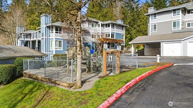 view of community featuring a garage and fence