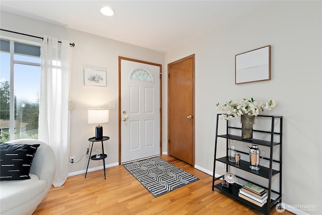 entrance foyer with recessed lighting, baseboards, and wood finished floors