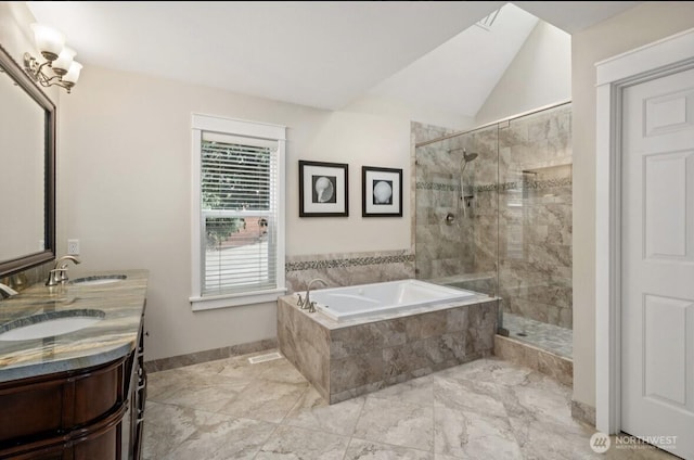 bathroom with a bath, a stall shower, and a sink